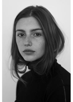 a black and white photo of a woman with freckled hair