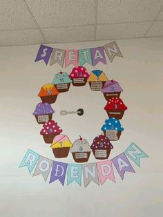 an office decorated with cupcakes and bunting on the wall for rohenday