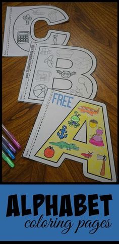 an alphabet coloring page with crayons and markers on the table next to it