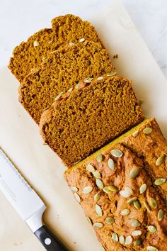 sliced loaf of pumpkin bread next to a knife