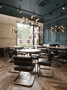 an empty restaurant with tables and chairs in the center, lights hanging from the ceiling