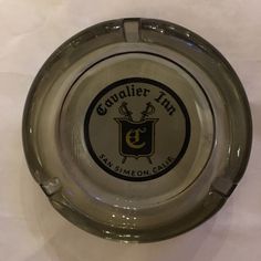 an empty glass ashtray with the logo of esqs lemon cafe on it