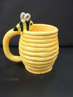 a close up of a cup with a bee on it