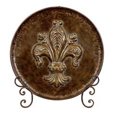 a decorative metal plate with fleur de lis on the front and center piece