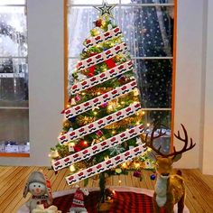 a decorated christmas tree in the middle of a living room with reindeer figurines