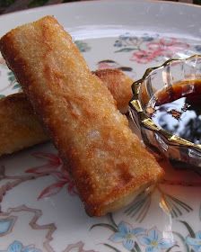 two fried food items on a plate with dipping sauce