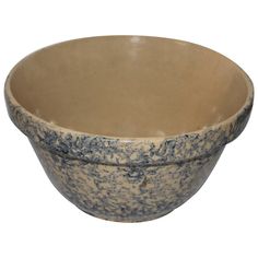 a blue and white bowl sitting on top of a table