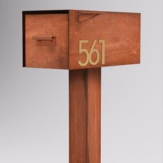 a wooden mailbox with the number sixty1 on it's front and side