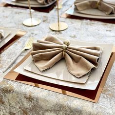 the table is set with napkins and place settings