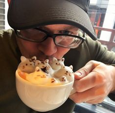 a man is taking a bite out of a dessert with white chocolate and sprinkles