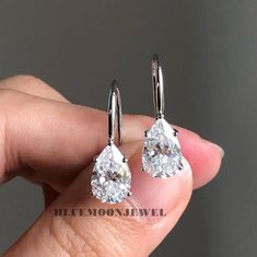 Pear Cut Moissanite Earrings, Solitaire Dangle Drop Custom Earrings, Pear Dangle Earrings For Wife, Daily Wear Simple Earrings. 𝐌𝐚𝐢𝐧𝐒𝐭𝐨𝐧𝐞𝐃𝐞𝐭𝐚𝐢𝐥𝐬 ➤𝐓𝐲𝐩𝐞: Moissanite ➤𝐂𝐮𝐭: Pear ➤𝐂𝐨𝐥𝐨𝐮𝐫: FG ➤ 𝐂𝐥𝐚𝐫𝐢𝐭𝐲: VVS1 ➤ 𝐖𝐞𝐢𝐠𝐡𝐭: 3.00 CT (approx) 𝐑𝐢𝐧𝐠 𝐃𝐞𝐭𝐚𝐢𝐥𝐬 At BlueMoon Jewels, we use only the highest quality materials to craft our beautiful jewelry. Our pieces are made with solid gold in your choice of 10k, 14k, or 18k purity, or with 925 sterling silver. We Engagement Earrings, Solitaire Earrings, Diamond Dangle Earrings, Moissanite Earrings, Beautiful Engagement Rings, Fish Hook Earrings, Garnet Earrings, White Gold Earrings, Custom Earrings