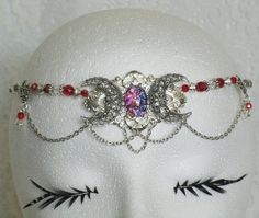 "This beautiful circlet has a sterling silver plated triple moon pendant with a glass dragons breath fire opal setting , sterling silver plated side pieces, red glass beads, clear glass beads, sterling silver plated beads and sterling silver plated chain. 20\" long adjustable to 24\" long. Lobster clasp." Adjustable Silver Jewelry For Fantasy Events, Silver Bohemian Jewelry For Fantasy Events, Adjustable Silver Spiritual Body Jewelry, Adjustable Fantasy Jewelry For Festivals, Silver Fantasy Jewelry For Festivals, Adjustable Fantasy Festival Jewelry, Spiritual Silver Body Jewelry For Festivals, Adjustable Silver Gothic Body Jewelry, Adjustable Gothic Jewelry For Festivals