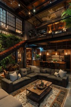 a living room filled with lots of furniture next to a spiral stair case on the wall