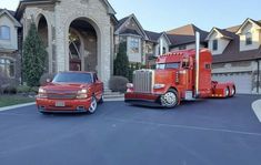 two red trucks parked in front of a house