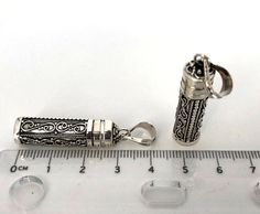 "This intricate .925 Sterling Silver Pendant was individually handcrafted to our specifications producing a charming and finely detailed keepsake. You can open it and store your lovely small stones, favor beads, love notes, and even a baby tooth, etc. Dimension with bail: 34mm x 8.5mm Dimension without bail: 30mm x 8.5mm Inside tube dimension: 24mm x 7mm Please select the chains you desire, The pendant and the chains all solid 925 sterling silver. The pendant chain necklace will ship with a gift Traditional Locket Jewelry For Keepsake, Sterling Silver Pendant Jewelry, Spiritual Engraved Rectangular Jewelry, Rectangular Engraved Antique Silver Jewelry, Engraved Round Pendant Jewelry For Personal Use, Filigree Pendant Jewelry For Keepsake, Sterling Silver Necklace For Personal Use, Ornate Rectangular Engraved Jewelry, Handmade Rectangular Keepsake Jewelry