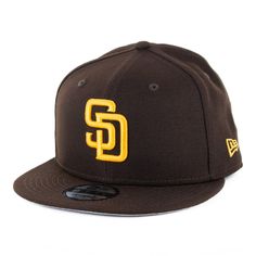 This is the New Era 9FIFTY San Diego Padres Game snapback hat. First unveiled for the 2020 MLB season, this is the official colorway for the Padres 2020 season. The technical color of this hat is burnt wood with a manilla yellow SD logo, but is commonly referred to as brown and gold. This is standard fit New Era 9FIFTY snapback hat with a plastic snap backstrap, flat visor and structured high crown. The technical New Era size for this hat is M/L although this snapback size is commonly referred t Sd Logo, Hats Snapback, San Diego Padres, Snapback Hats, Dark Brown, Mlb, New Era, San Diego, Yellow