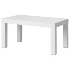 a white table sitting on top of a white floor