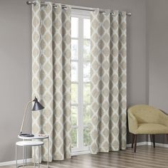 the curtains in this room are gray and white, with an intricate pattern on them