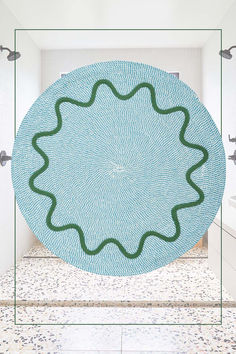 a bathroom with a circular blue rug on the floor