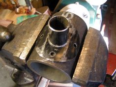 an old metal object sitting on top of a table