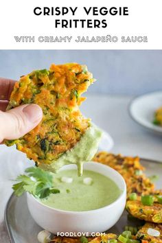 a person dipping some food into a bowl with guacamole sauce on it