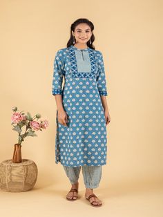 Blue dabu flower printed straight kurta, has a mandarin collar, mirror and katha embroidered yoke, three-quarter sleeves and stripes Print afgani Pants has Elasticated Waistband Fabric: 100% Cotton Color: Blue Note: Available in other colors Wash Care Instruction - Dry Clean Only The product will be shipped within 15-20 days of order placed Size Chart: Kurta Size XS S M L XL XXL XXXL Bust 36 38 40 42 44 46 Waist 32 34 36 38 40 42 Hip 38 40 42 44 46 48 Shoulder 14 14.5 15 15.5 16 16.5 Armhole 18 Cotton Kurta With Block Print And 3/4 Sleeve, Cotton Kurta With Printed Border For Diwali, Fitted Cotton Kurta With 3/4 Sleeves, Diwali Cotton Kurta With Printed Border, Spring Indigo Cotton Kurta, Cotton Straight Kurta With Printed Border, Indigo Block Print Straight Kurta, Cotton Kurta With Printed Border For Festivals, Straight Cotton Kurta With Printed Border