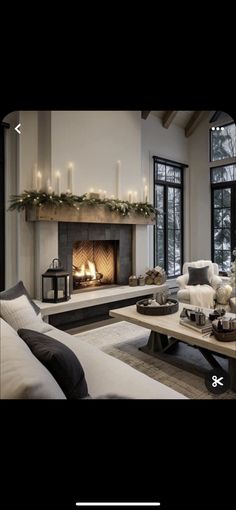 a living room filled with furniture and a fire place in front of a large window