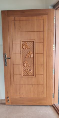 a wooden door with decorative carvings on the front and side panels inlayed to it