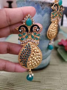 Indian Gold Plated jewelry Gorgeous gold plated Bollywood style earrings very unique one of its kind. High quality gold dangle earrings studded with colored stone. Traditional Light Weight Indian Jhumki Earrings with beads/Jhumka Earrings, Indian Earring, Indian Jhumka. These Hand Crafted beautiful Dangle Earrings works for any grand occasion or festival. Pair it with your salwar kameez or Saree ...goes well with all the outfits. Check our collections on- https://www.etsy.com/shop/IndusFinds?ref=search_shop_redirect Thank you so much visiting our shop. Check our collections on- https://www.etsy.com/shop/IndusFinds?ref=search_shop_redirect Color, shades, texture displayed may slightly vary from the actual product due to digital image limitations. We request you to consider these minor varia Green Meenakari Gold-plated Earrings, Kundan Earrings With Peacock Design For Celebrations, Temple Jewelry Pendant Earrings With Latkans, Gold Plated Pendant Earrings With Intricate Design, Green Pendant Earrings For Festive Occasions, Gold Plated Meenakari Chandbalis For Gift, Gold Plated Meenakari Chandbalis As Gift, Traditional Pendant Earrings For Party, Green Intricate Design Gold-plated Earrings