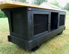 a large black dog house sitting in the grass