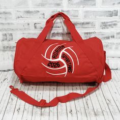 This personalized Volleyball bag has up to three lines of custom text! Take a tote bag to the court, or a duffle bag for a weekend trip. Add a name for a super personalized on the go bag. With a design you won’t find anywhere else, Persunly duffle bags show off your favorite activity, while keeping all your gear handy and protected. Our three sizes are roomy and fit shoes, clothing, balls, and small sporting equipment. Made from a sturdy denier polyester canvas, and with tough zippers and straps, these totes and duffles are built to last. CUSTOM BAG OPTIONS: Custom bag style: Tote, Small Duffle, or Large Duffle. Dimensions listed below. Custom bag color: Drop down menu options are available based on what coordinates with the design colors. Not all designs are available in all colors or sty Personalized Red Bags For Travel, Personalized Bags For Everyday School Use, Sporty Tote Duffle Bag For School, Sporty School Tote Duffle Bag, School Spirit Personalized Bags For Everyday Use, Personalized School Spirit Bags, Customizable School Spirit Bags, Sporty Red Gym Bag, Personalized Sporty School Bag