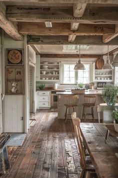 an open kitchen with wooden floors and white walls, along with lots of counter space