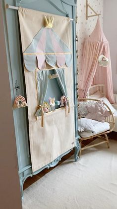 a child's bedroom with pink and blue decor