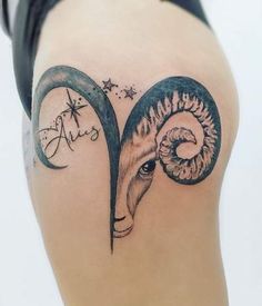 a woman's thigh with a tattoo of a ram and the word aris on it