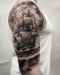 a man's arm with a ship on it