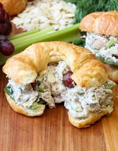 a croissant filled with chicken salad and grapes