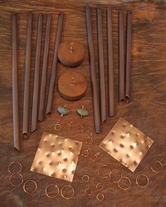 several different types of rings and other items on a wooden surface with holes in the middle