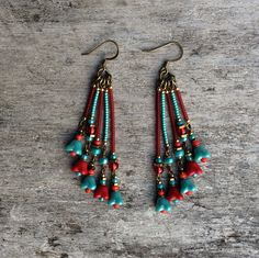 Beautiful and original red and pale blue tones, bronze bohemian Czech glass leaf earrings.  Spiritual Jewelry designed and carefully handmade by Rushweaver Jewellery in an ancient earthy tribal style.  These boho beauties dangle 78mm from the top of nickel free brass ear wires. For all free spirited women who want to enjoy their unique style! Turquoise Bohemian Flower Earrings For Gift, Turquoise Handmade Tassel Earrings For Festivals, Bohemian Chandelier Earrings With Ear Wire For Festivals, Bohemian Chandelier Earrings For Pierced Ears, Bohemian Dangle Earrings For Jewelry Making, Bohemian Brass Beaded Earrings With Ear Wire, Bohemian Dangling Beads Drop Earrings, Bohemian Turquoise Beaded Earrings With Brass, Bohemian Turquoise Beaded Earrings In Brass