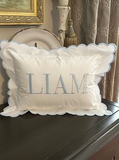 a pillow that says i am sitting on top of a dresser