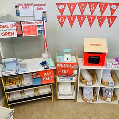 an office cubicle with various items on the desk and in front of it is a sign that says post office