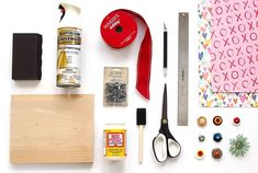 craft supplies are laid out on a white surface with scissors, tape, glue, and other items