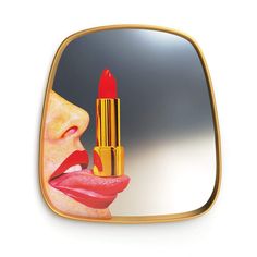 a mirror with a painting of a woman holding a lipstick