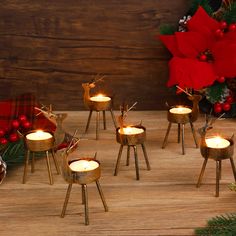 christmas decorations with lit candles on wooden table