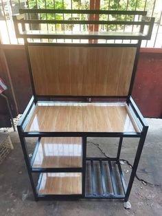 a wooden shelf sitting in the middle of a room next to a metal rack with shelves on it