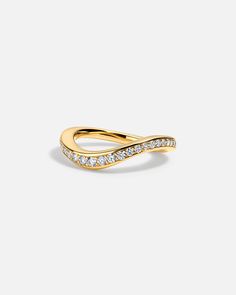 a yellow gold ring with diamonds on the sides and a curved band in the middle