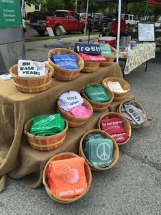 baskets with food are on display at an outdoor market table in front of a sign that says fresh