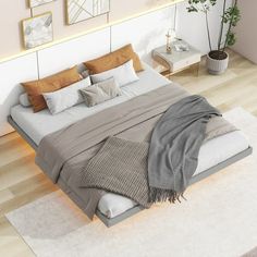 a large bed sitting on top of a hard wood floor next to a white rug