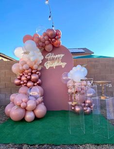 balloons and decorations are on display in front of a sign that says, happy birthday