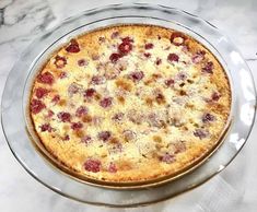 a cake sitting on top of a glass plate covered in toppings and crumbs