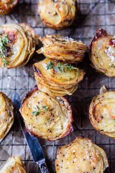 baked potatoes on a baking sheet with a knife